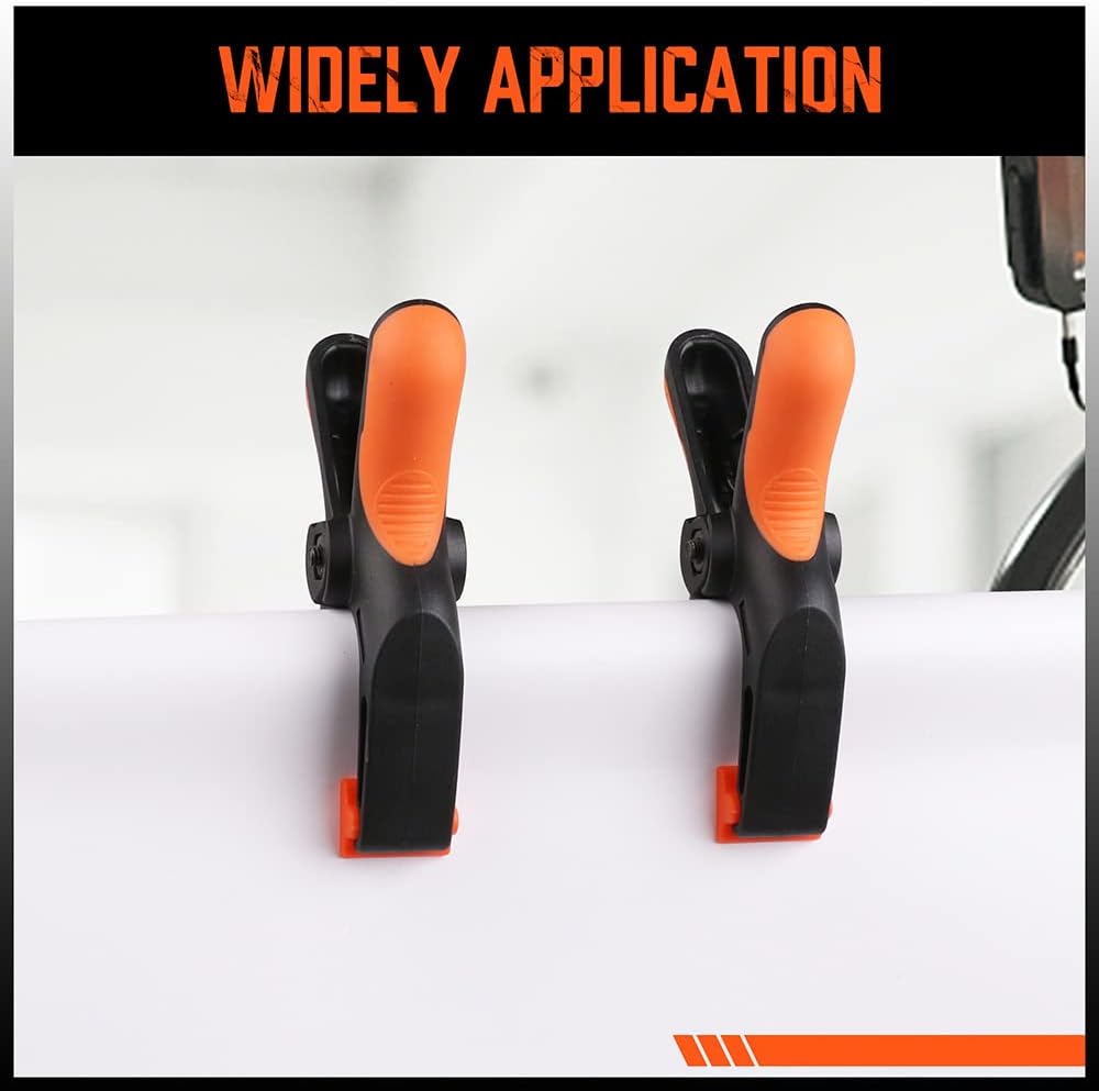 Heavy duty 5-inch orange and black spring clamps with flexible jaw pads and ergonomic handles for woodworking, DIY, and backdrop support