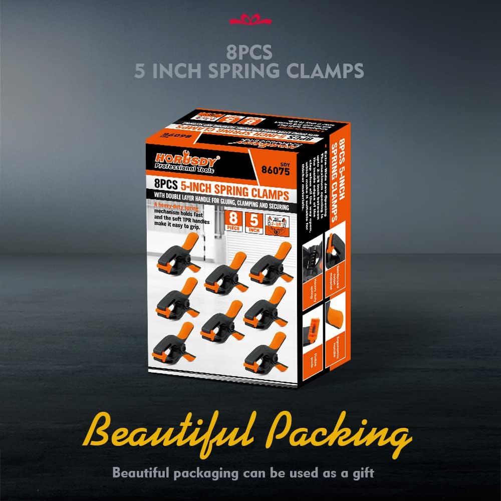 Heavy duty 5-inch orange and black spring clamps with flexible jaw pads and ergonomic handles for woodworking, DIY, and backdrop support