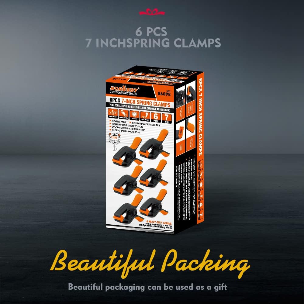 Heavy duty 7-inch spring clamps with orange and black ergonomic handle and flexible jaw pads for woodworking and photography